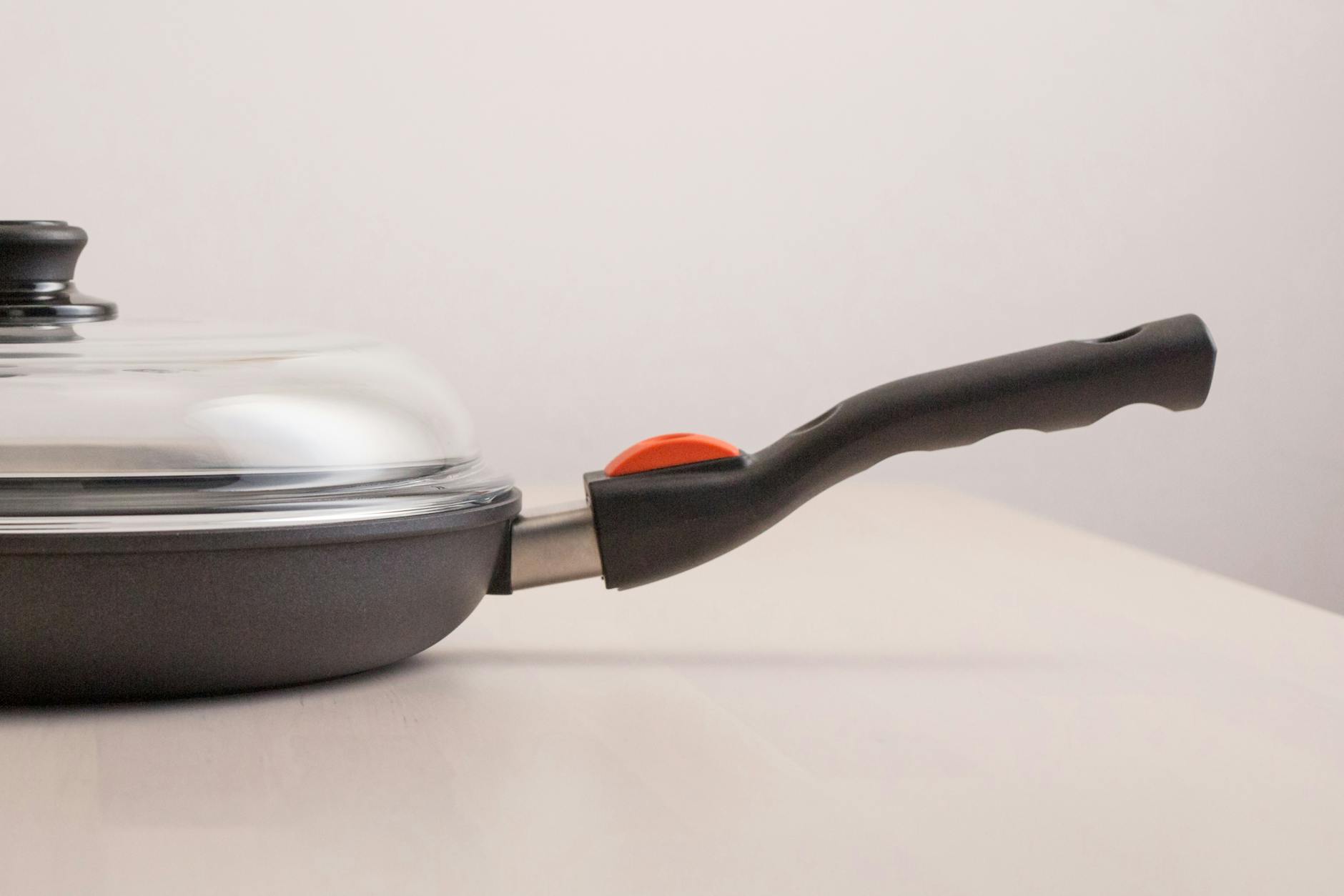 A high-quality nonstick frying pan with a glass lid perfect for modern kitchens.