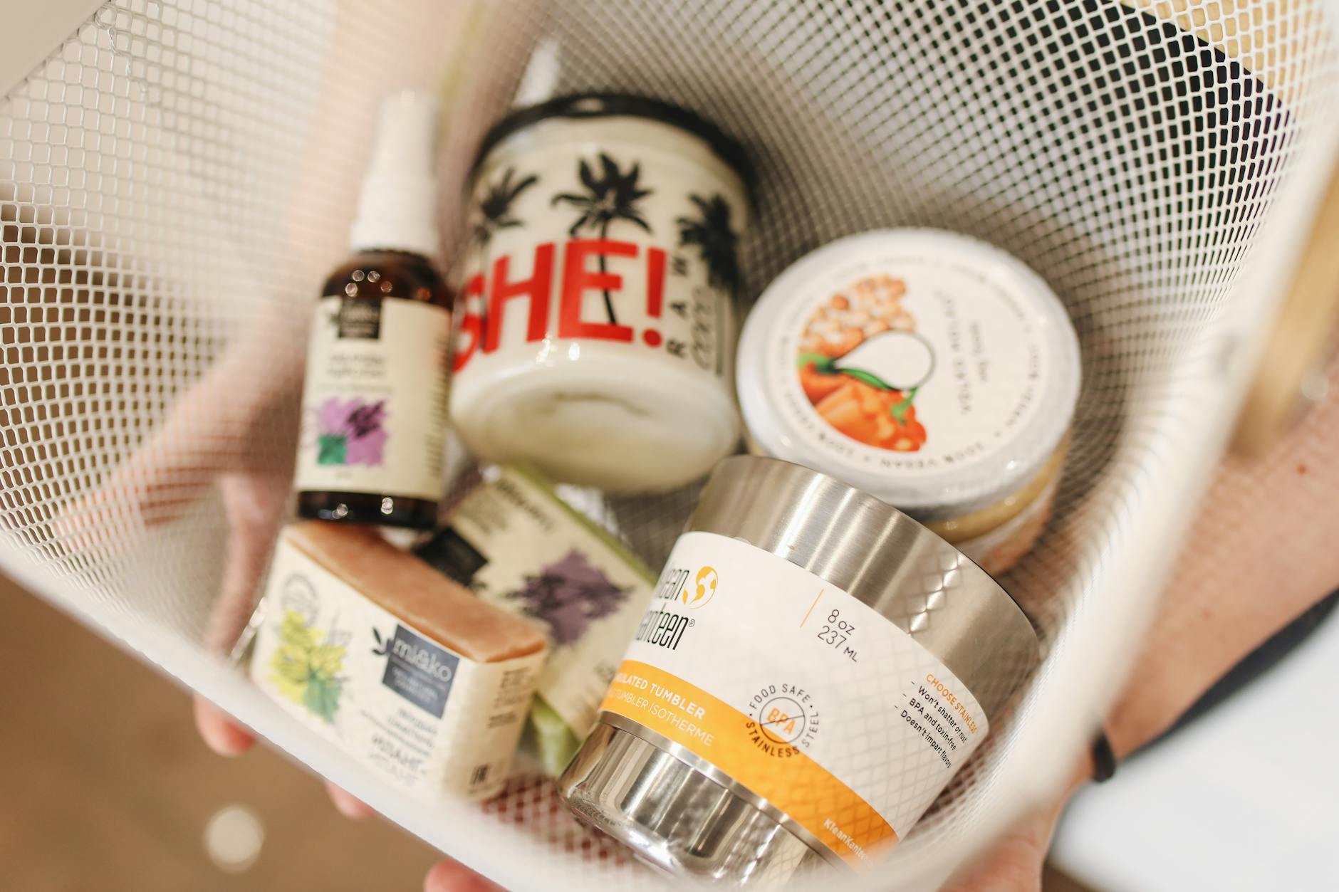 A basket containing various eco-friendly and natural products.