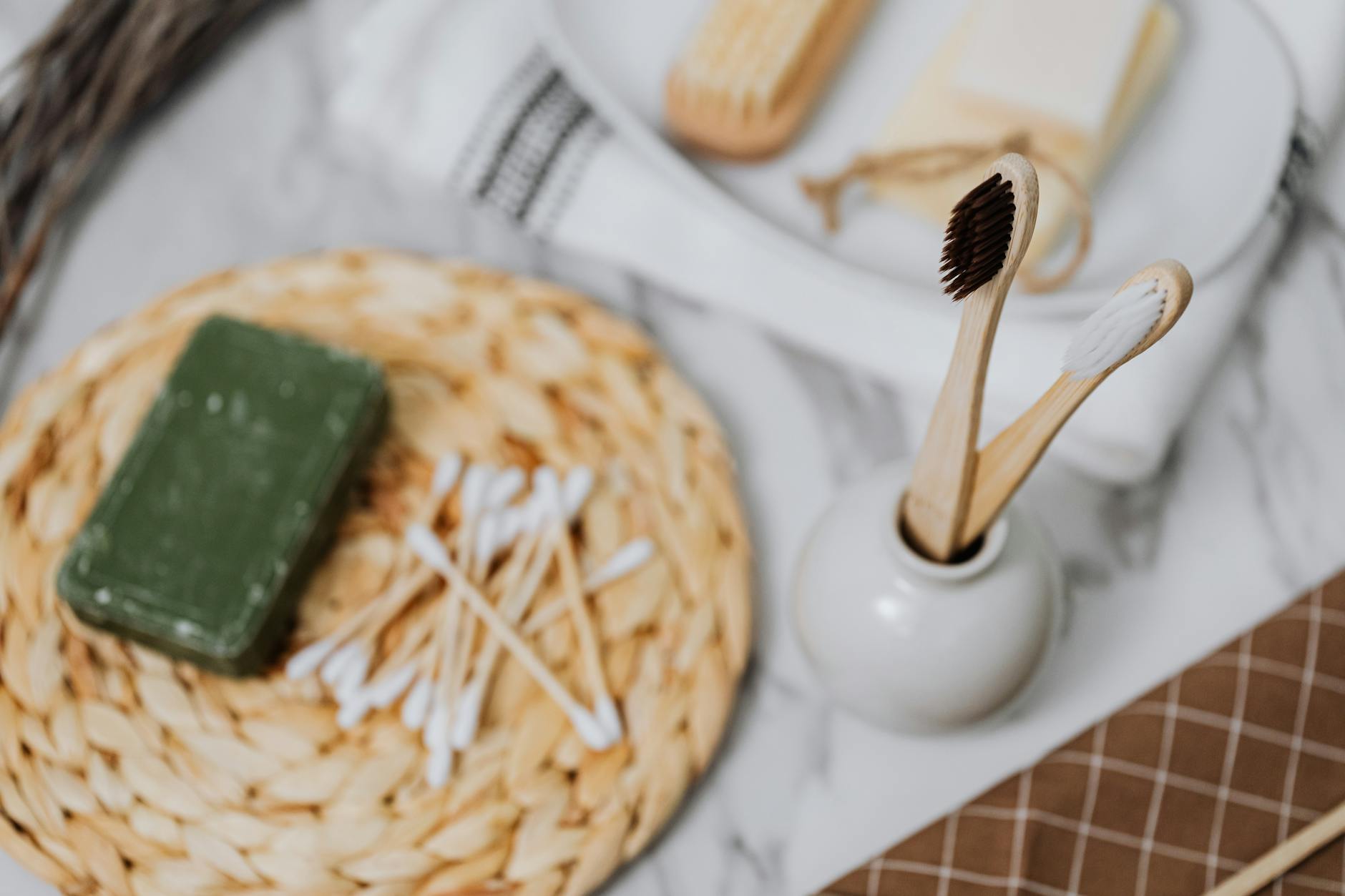 Discover eco-friendly bathroom essentials including wooden toothbrushes and bamboo cotton swabs for a zero waste lifestyle.